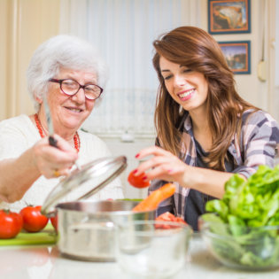 patient assisting caregiver at cooking