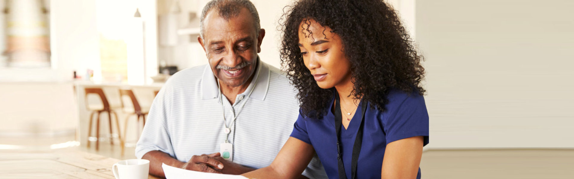 caregiver and patient looking at the paper