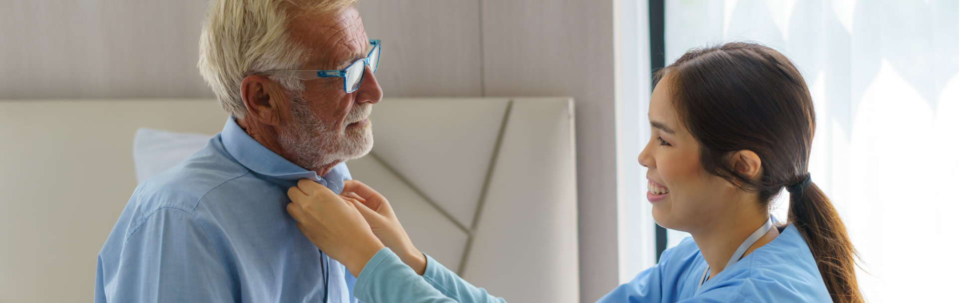 caregiver fixing patients collar