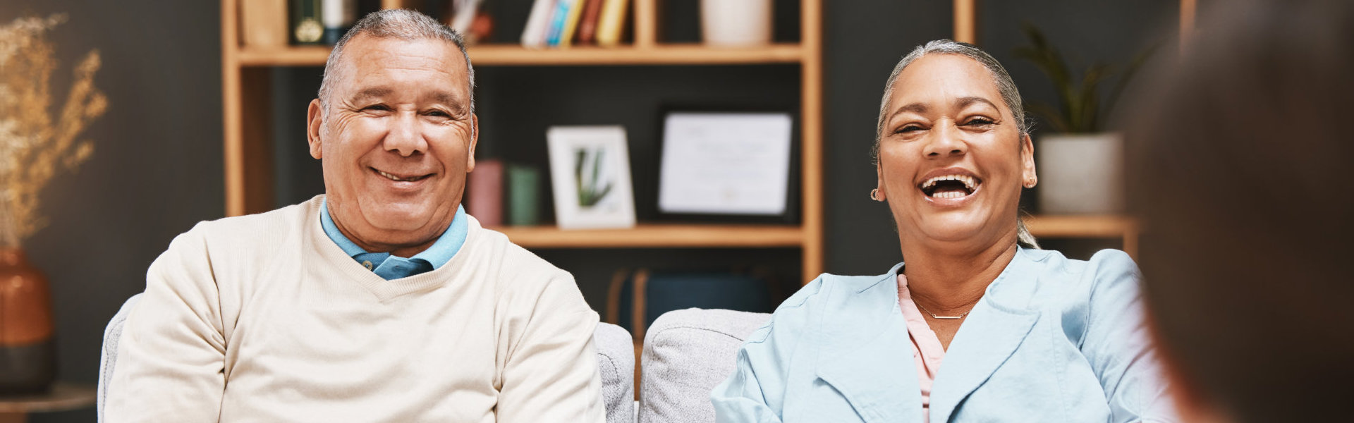 man laughing with a woman talking to a funny therapist